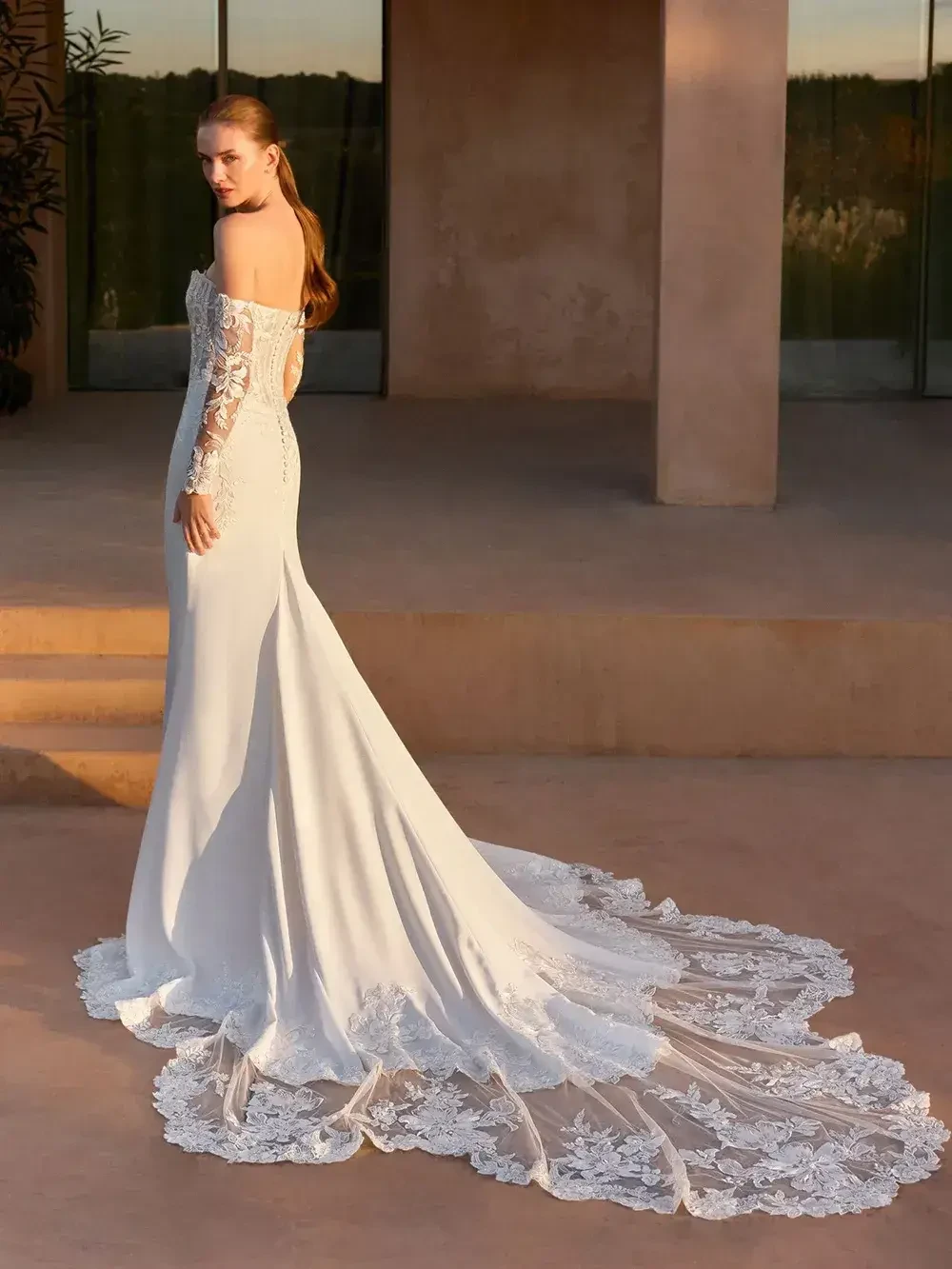 model is wearing a strapless fit and flare wedding dress