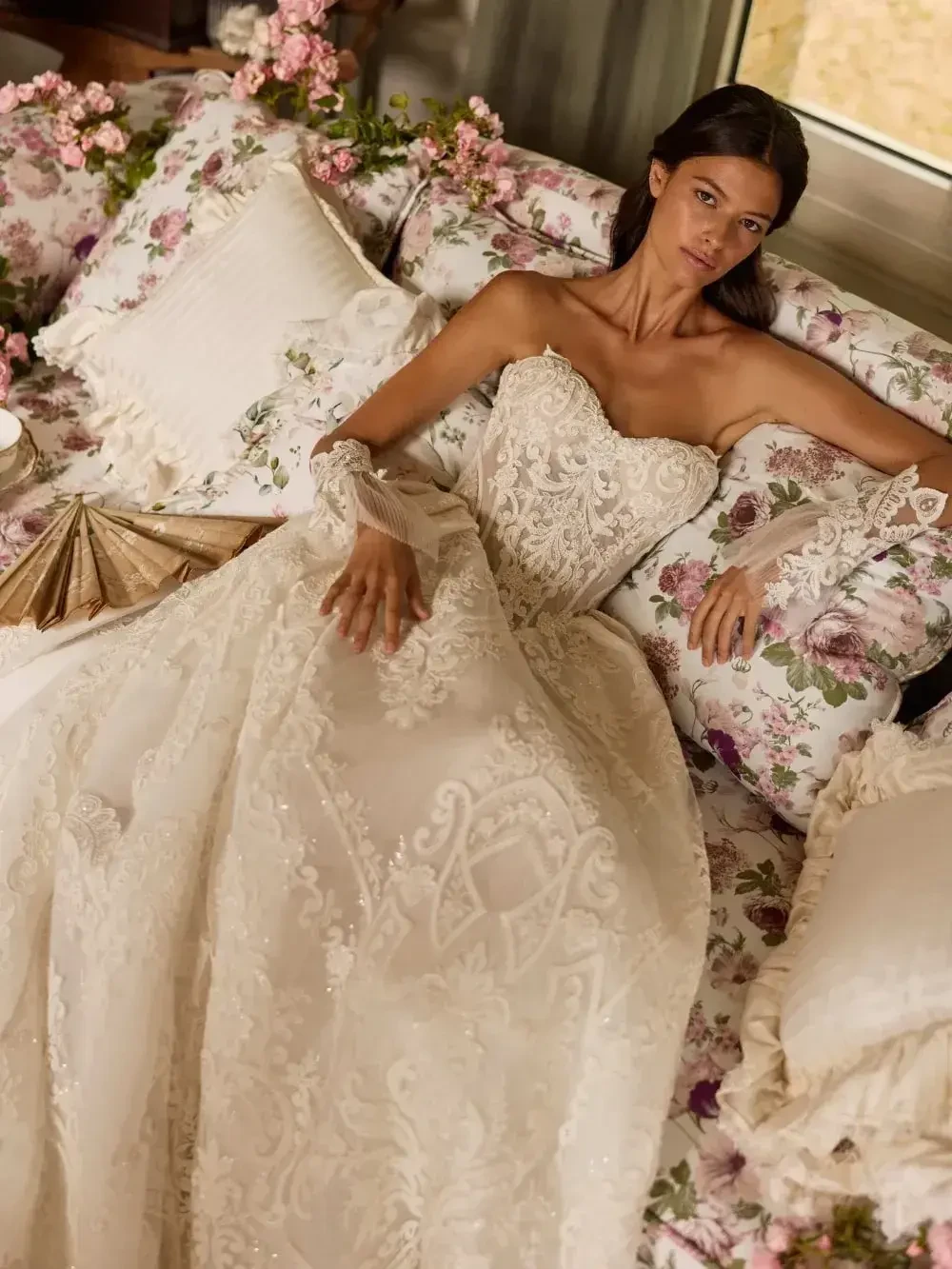 model is wearing a strapless ball gown wedding dress