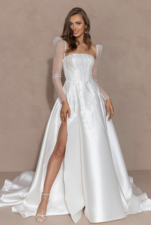 Model wearing a white gown by Evie Young. Mobile image