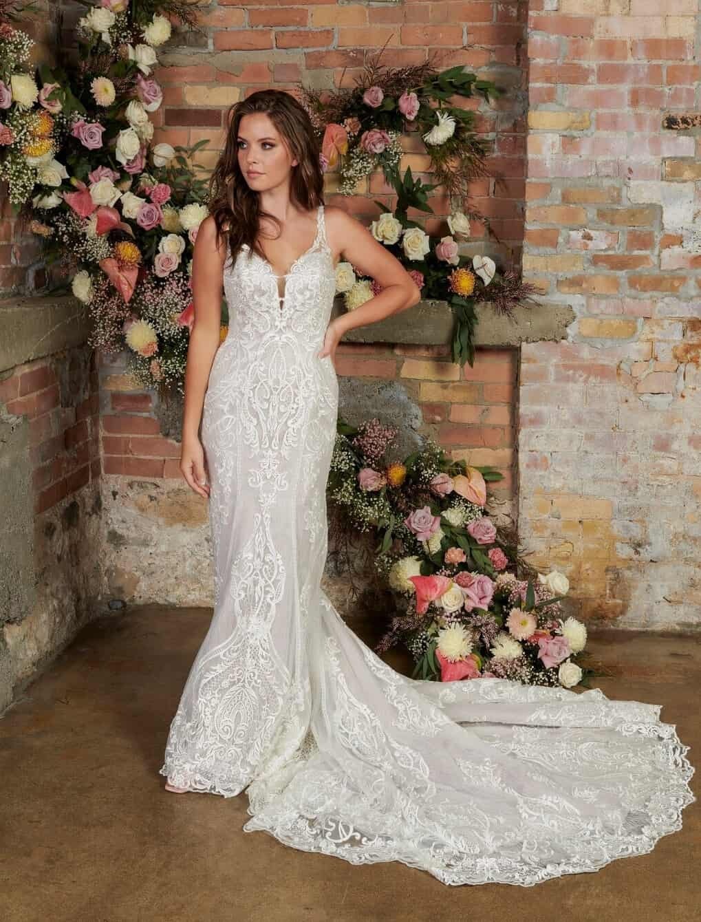 Model wearing a white gown by Mia Solano. Mobile image